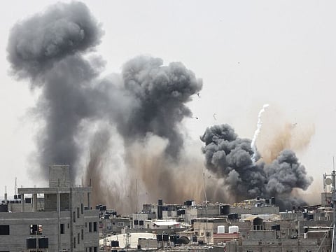 Smoke rises above buildings in Rafah, in the southern Gaza Strip, following an Israeli strike on May 12, 2023.  