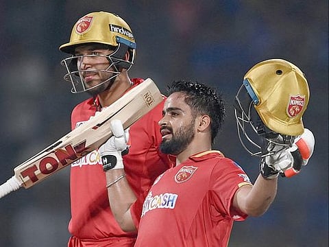 Punjab Kings' Prabhsimran Singh (R) celebrates after scoring a century during the IPL match against Delhi Capitals at the Arun Jaitley Stadium in New Delhi on May 13, 2023. 