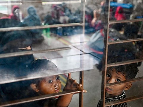 Women take shelter with their children in Shahpori island on the outskirts of Teknaf.