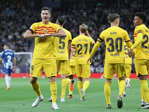 Barcelona's Robert Lewandowski (left) celebrates after scoring the opening goal during the La Liga match against Espanyol on Sunday.