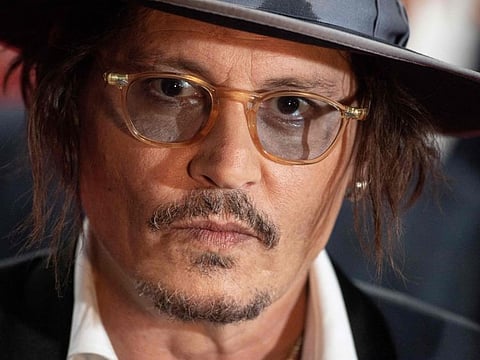 (FILES) US actor Johnny Depp arrives on the red carpet of the 47th Deauville US Film Festival in Deauville, western France, on September 5, 2021. Far from the media buzz around Maïwenn and Johnny Depp, stars of "Jeanne du Barry" which opens the Cannes Film Festival on May 16, 2023, this film could not be more "academic, slow, classic", its director admits. (Photo by LOIC VENANCE / AFP)