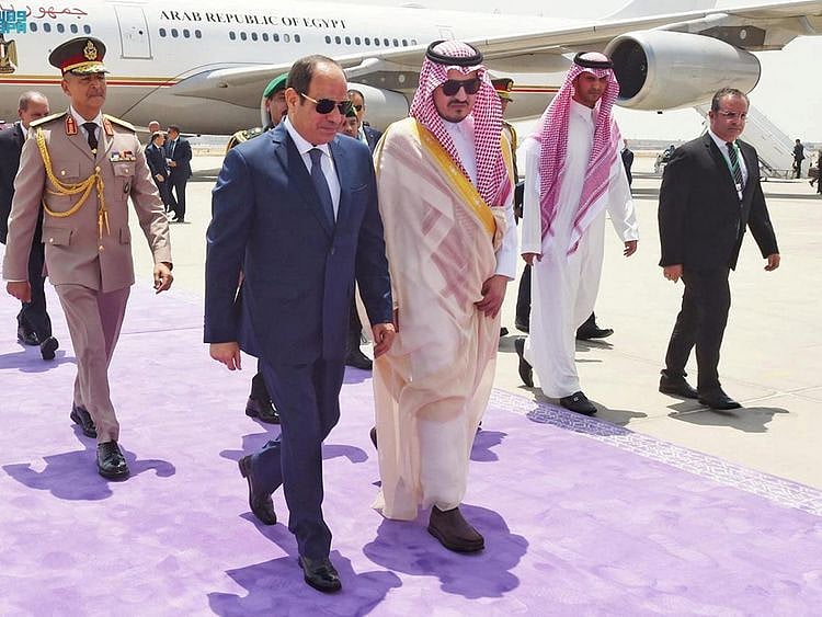 Egypt's President Abdul Fattah Al Sisi is received by Deputy Emir of Makkah, Prince Badr Bin Sultan, as he arrives to attend the Arab League Summit in Jeddah, on May 18, 2023. 