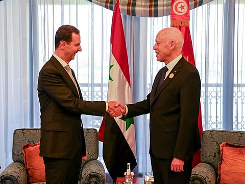 Tunisian President Kais Saied, right, shakes hand with Syrian President Bashar Al Assad, in Jeddah, during the Arab summit, on May 19, 2023.  