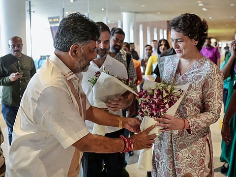 Congress leader Rahul Gandhi and party General Secretary Priyanka Gandhi Vadra being welcomed by Karnataka Deputy-CM designate DK Shivakumar as they arrive to attend the oath taking ceremony of newly-elected Karnataka Government, in Bengaluru on Saturday.  