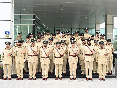 Al Khawaneej Police Station staff with Lieutenant General Abdullah Khalifa Al Marri, Commander-in-Chief of Dubai Police, during an inspection visit to the station. 