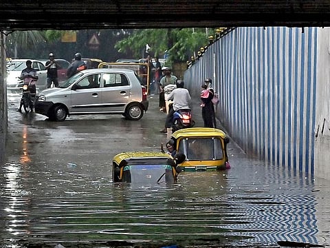 Vehicles wade through a waterlogged underpass after heavy rainfall, near K R Circle, in Bengaluru on Sunday. 