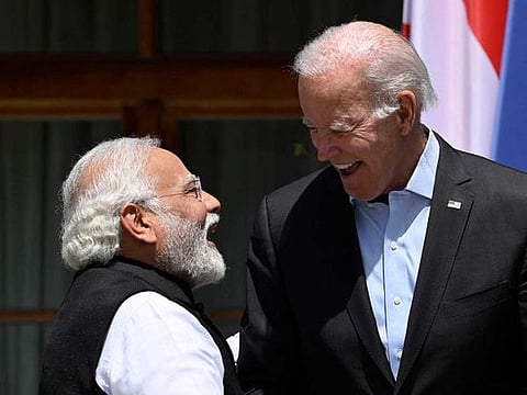 US President Joe Biden (R) greets India's Prime Minister Narendra Modi 