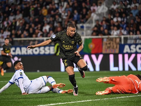 Paris Saint-Germain's forward Kylian Mbappe (centre) in action during the French L1 match between AJ Auxerre at Stade de l'Abbe-Deschamps in Auxerre, central France.