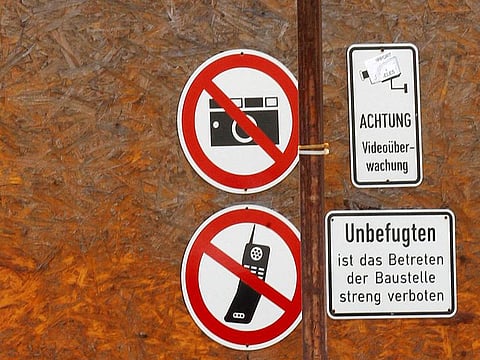  Signs forbidding photography and mobile phones are pictured on a fence to part of the construction site of the new headquarters of Germany's intelligence agency Bundesnachrichtendienst (BND) in Berlin, July 11, 2011.