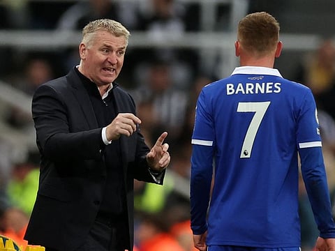 Leicester City manager Dean Smith (left) gives instructions to Harvey Barnes.