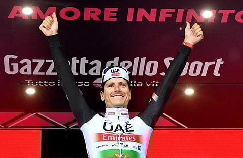 UAE Team Emirates' Joao Almeida celebrates on the podium after winning stage 16.
