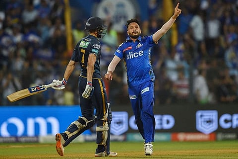 Mumbai Indians' Akash Madhwal (right) celebrates after taking the wicket of Gujarat Titans' Shubman Gill during the Indian Premier League match at the Wankhede Stadium in Mumbai.