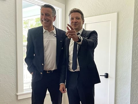 Actor Jeremy Renner, right, poses for a photo with former Nevada Gov. Brian Sandoval, now president of the University of Nevada, Reno, on Monday, May 22, 2023,  in Carson City, Nev. Renner spent Monday pitching an amendment to Nevada lawmakers to include his home region in a tax deal to expand the film industry to Las Vegas. But his hopes of making northern Nevada a film hub are likely on hold after the bill sponsor said it's too late to add his project.  (AP Photo/Gabe Stern)