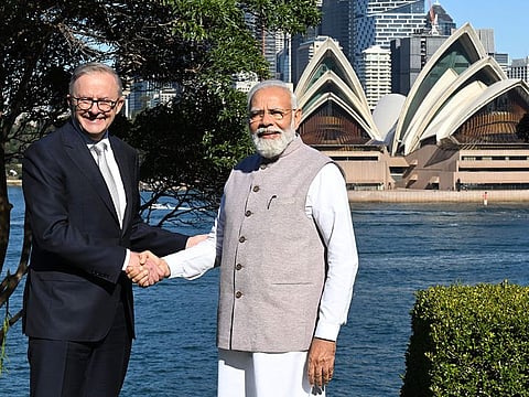 India's Prime Minister Narendra Modi (R) shakes hands with Australia's Prime Minister Anthony Albanese in front of the Sydney Opera House at Admiralty House in Sydney on May 24, 2023. 