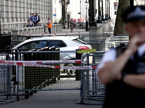 Police tapes site where a car crashed into the front gates of Downing Street in London on May 25, 2023.  