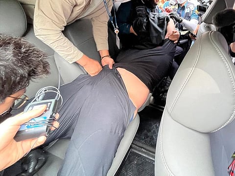 Police officers in plain clothes arrest an airplane passenger at Daegu International Airport in Daegu, South Korea, as he is suspected of opening an emergency exit door on an Asiana Airlines plane during a flight. 
