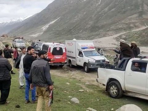 Rescue teams and police officials at the site where an avalanche struck in the Shounter Top area in the Astore district of northern Gilgit-Baltistan region on May 27, 2023.