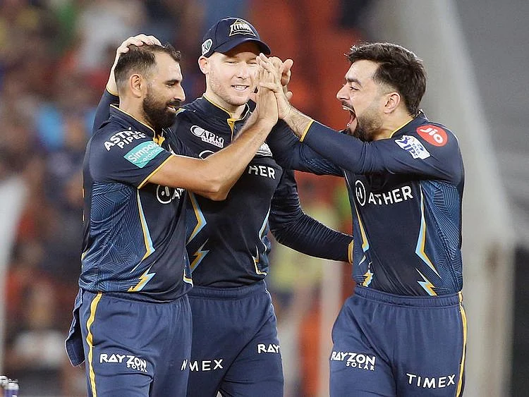Gujarat Titans' Mohammad Shami celebrates the dismissal of Mumbai Indians skipper Rohit Sharma 