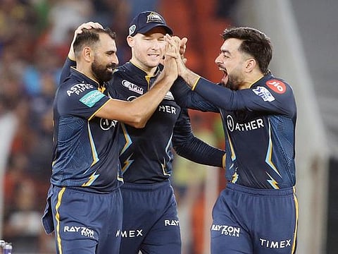 Gujarat Titans' Mohammad Shami (left) celebrates the dismissal of Mumbai Indians skipper Rohit Sharma during the IPL second qualifier match at Narendra Modi Stadium in Ahmedabad on Friday. 