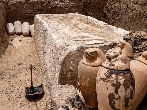 Clay pots and ritual vessels are placed around a stony bed used for mummification, in the Saqqara necropolis south of Cairo, where archaeologists unearthed two human and animal embalming workshops, as well as two tombs, on May 27, 2023.  