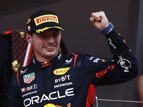 Red Bull's Max Verstappen celebrates on the podium after winning the Monaco Grand Prix.