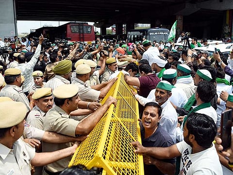 Farmers being stopped by police personnel at the Ghazipur border who arrive to join the protesting wrestlers' marching towards the new Parliament House against Wrestling Federation of India (WFI) president Brij Bhushan, in New Delhi on Sunday, May 28, 2023. 