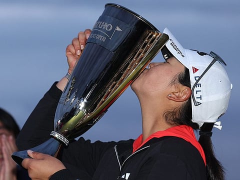Rose Zhang kisses the trophy after winning the Mizuho Americas Open golf tournament