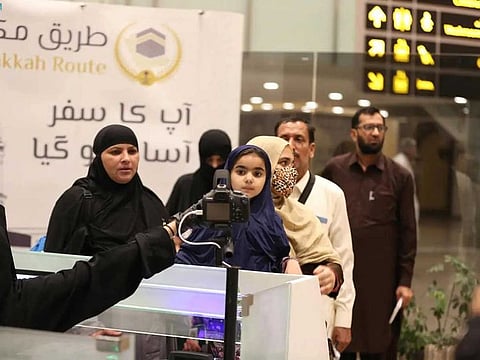 Pakistani Hajj pilgrims check in for their flight through a Makkah Route initiative at the Islamabad International Airport in Islamabad on June 4, 2023. 