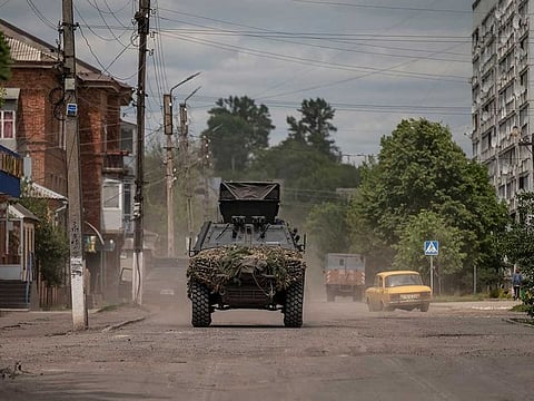 An armoured vehicle rides on a street, amid Russia's attack on Ukraine, near the Ukraine-Russia border in the town of Vovchansk, in Kharkiv region, Ukraine June 5, 2023. 