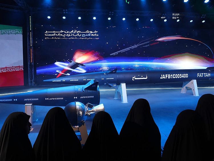 Women look at Fattah missile at a ceremony in Tehran, on June 6, 2023.  