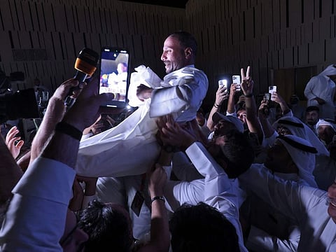 Kuwaiti candidate and former parliament speaker Marzouq Al Ghanim celebrates with his supporters following the announcement of his victory in legislative elections, in Kuwait city, on early June 7, 2023.  