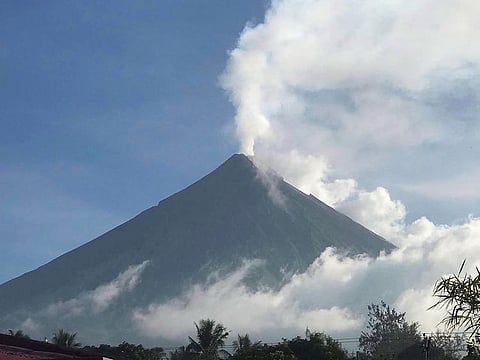 Mayon Volcano spewing white smoke.