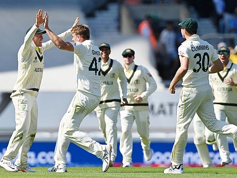 Australia's Cameron Green (2L) celebrates taking the wicket of India's Cheteshwar Pujara (unseen)  during day 2 of the World Test Championship final at The Oval, in London, on June 8, 2023.  