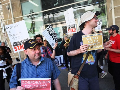 Writers Guild of America East members join United Musicians and Allied Workers as they picket at the Penske Media Corporation's offices in New York City. 