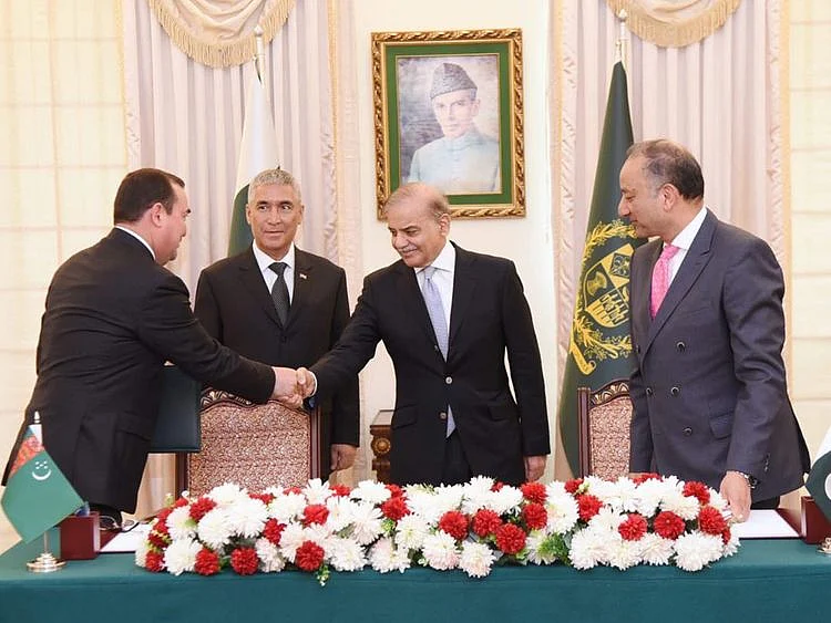 Pakistan’s Prime Minister Shehbaz Sharif and Turkmenistan State Minister Maksat Babayev shake hands at the signing ceremony of a joint implementation plan to expedite the TAPI gas pipeline project in Islamabad on June 8, 2023.  