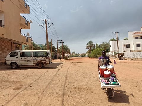 A man pushes a cart down a street in Khartoum on June 9, 2023, amid ongoing fighting.  