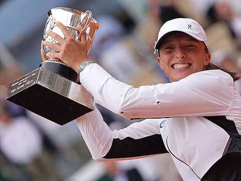 Poland's Iga Swiatek raises the trophy Suzanne Lenglen following her victory over Czech Republic's Karolina Muchova during their final in Paris on Saturday.