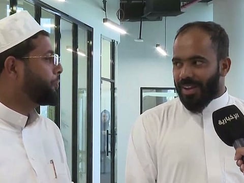 Indian pilgrim Shuaib Al Din (right) talking to Al Ekhbariya. The interpreter appears on left.