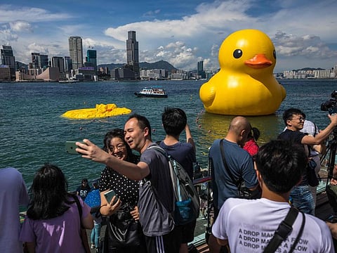 People at Victoria Harbour in Hong Kong on June 10, 2023.  