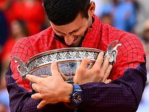 Serbia’s Novak Djokovic hugs the trophy after beating Norway’s Casper Ruud in the men’s singles final of the French Open tennis tournament at the Philippe Chatrier Court in Paris on June 11, 2023. That was his third French Open triumph and the 23rd Grand Slam title.