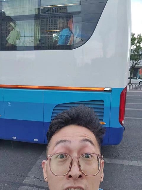 Liu Yuhang takes a selfie as Argentine football player Lionel Messi is seen riding a team bus en route to a training session in Beijing.