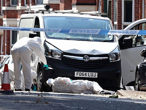  Police forensics officers work around a van with a shattered windscreen, inside a police cordon on Bentinck Road in Nottingham, central England, following a ‘major incident’ in which three people were found dead. 