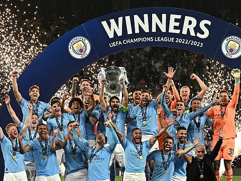 Manchester City's German midfielder Ilkay Gundogan holds aloft the European Cup trophy as they celebrate winning the UEFA Champions League final at the Ataturk Olympic Stadium in Istanbul, on June 10, 2023. Manchester City beat Inter Milan 1-0. 