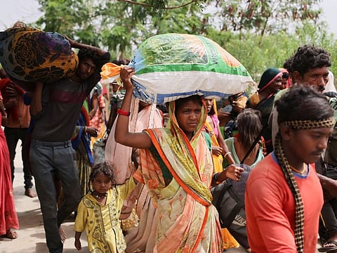 People arrive at a shelter in Naliya after they were evacuated from their homes before the arrival of cyclone Biparjoy, in the western state of Gujarat, India, June 14, 2023.