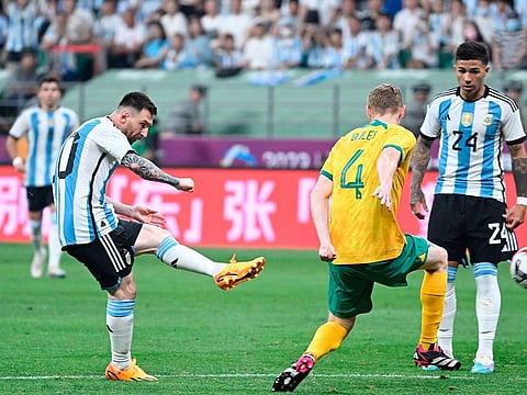 Argentina's Lionel Messi (2L) vies during a friendly football match against Australia at the Workers' Stadium in Beijing.