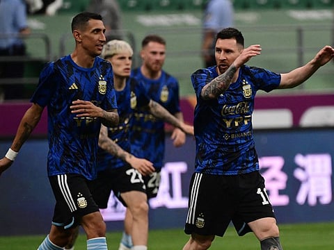 Argentina's Lionel Messi (R) with teammates ahead of a friendly match against Australia at the workers' stadium in Beijing on Thursday.