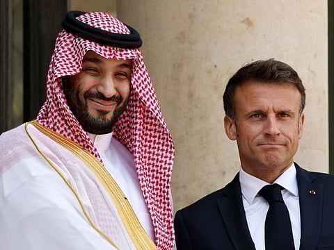 France's President Emmanuel Macron greets Saudi Crown Prince Mohammed bin Salman at presidential Elysee Palace in Paris.