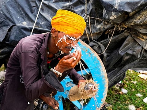 A man splashes water on his face to cool himself on a hot summer afternoon in Lalitpur district in northern Uttar Pradesh state, India, Sunday, June 18, 2023.