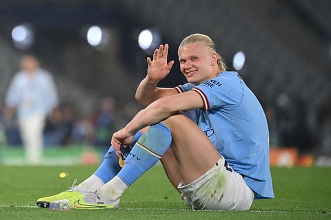 TOPSHOT - Manchester City's striker Erling Haaland waves to fans as he celebrates after the Champions League final win over Inter Milan at the Ataturk Olympic Stadium in Istanbul.