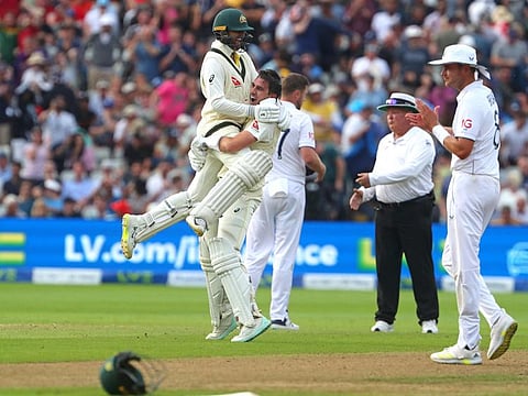 England's Stuart Broad (right) applauds as Australia's Pat Cummins (centre) celebrates with Nathan Lyon after winning the first Ashes Test at Edgbaston in Birmingham on Monday.